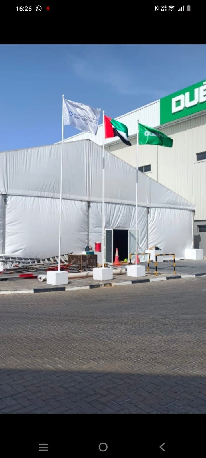 6 m freestanding flag pole with UAE flag outside office building