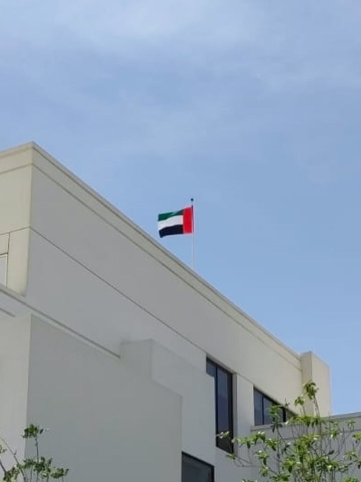 UAE flag flying on villa rooftop flag pole